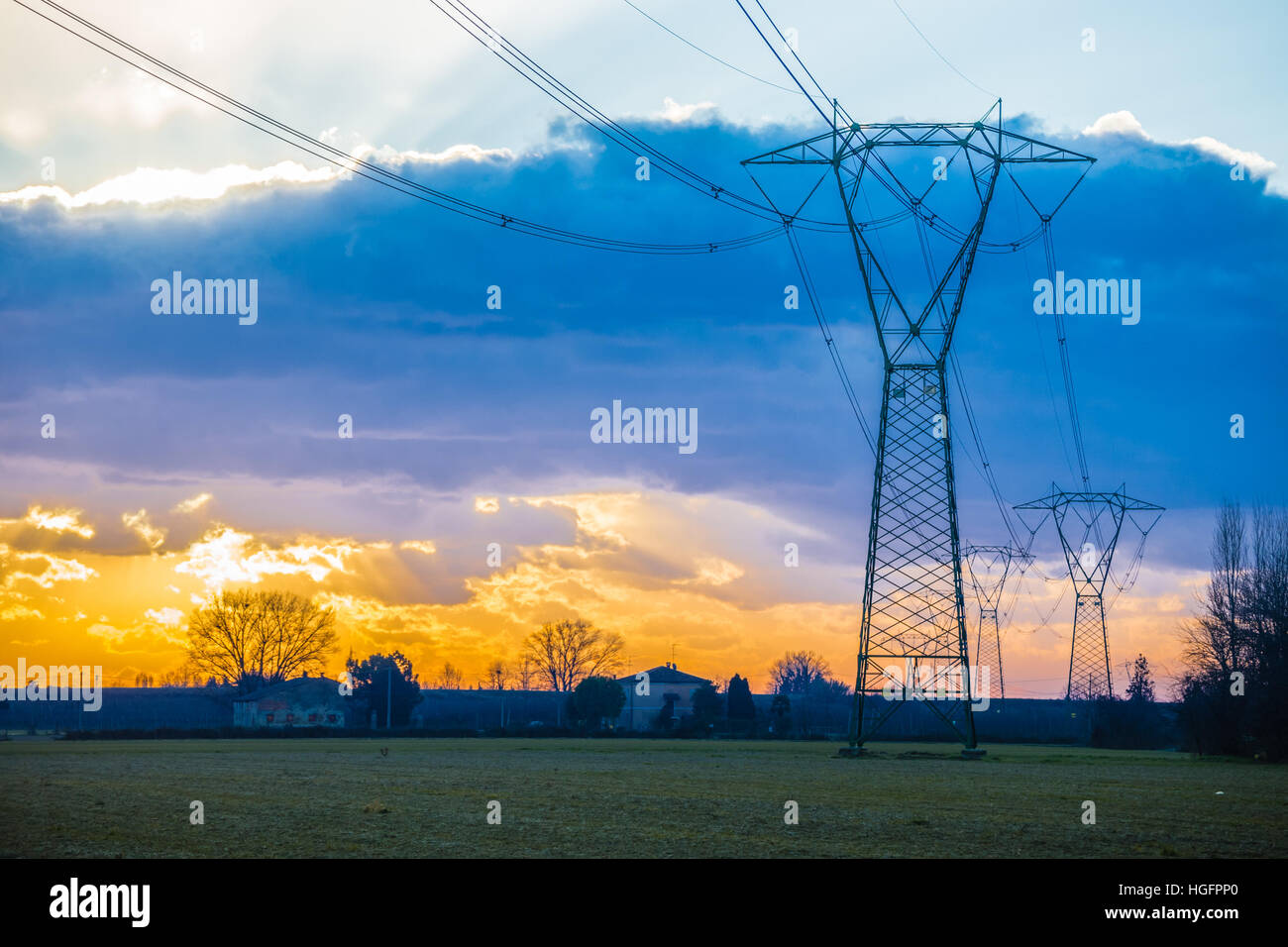 Winter sunrise on high voltage pylons in the countryside in Italy Stock ...