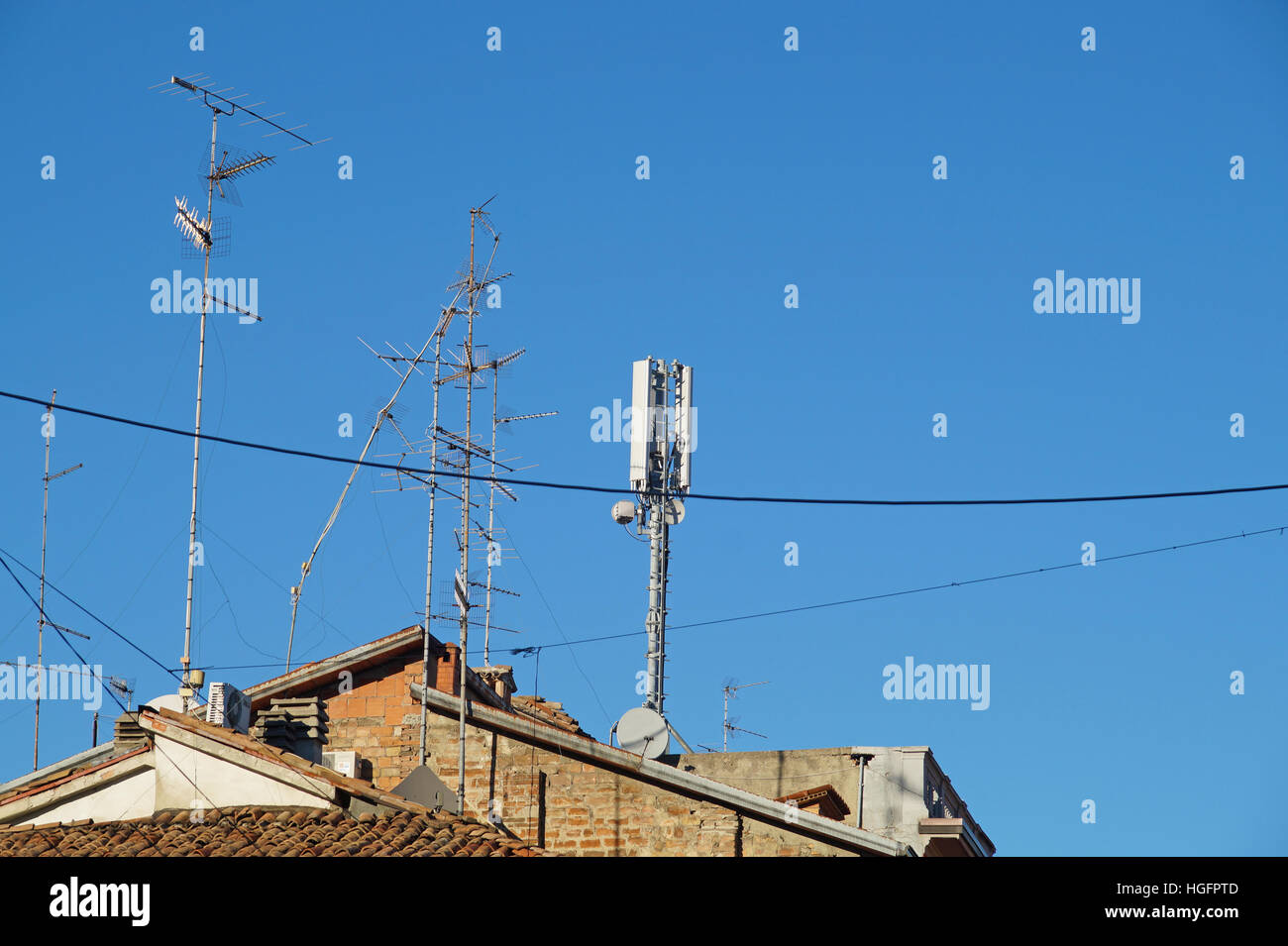 television antenna on roof with blue sky Stock Photo