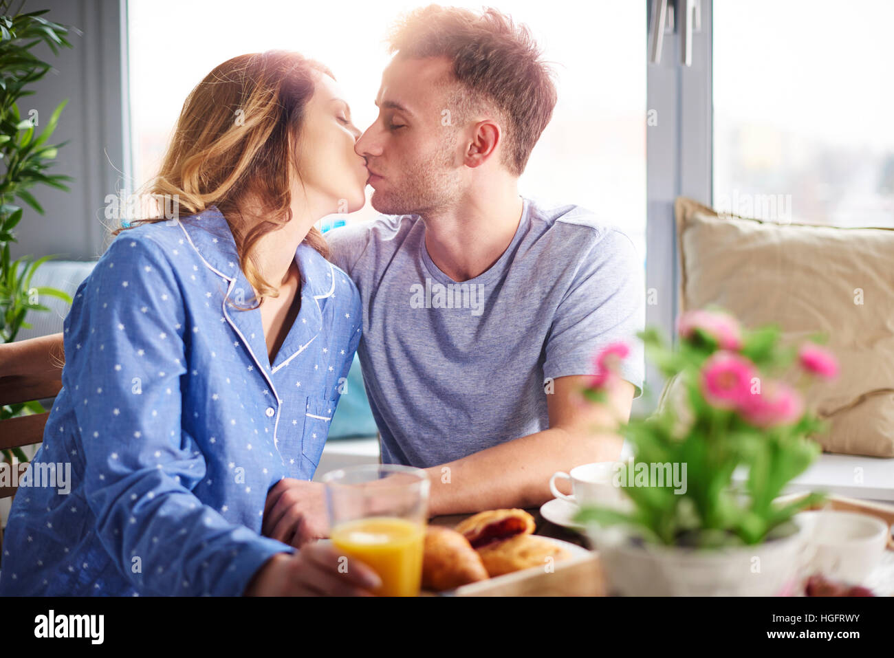 Young couple kissing in the kitchen Stock Photo