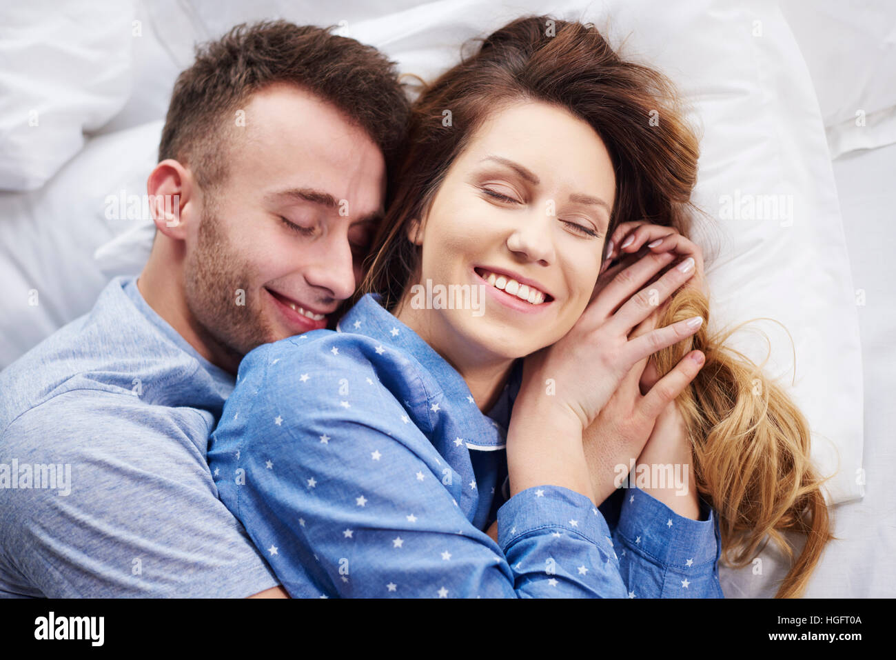 Young couple hugging in bed at the morning Stock Photo - Alamy