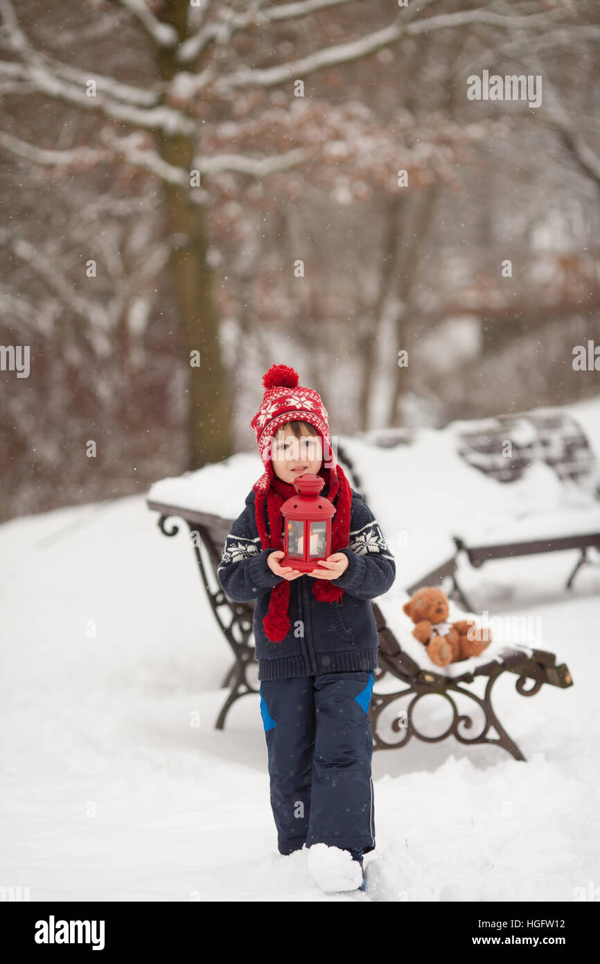 Cute little caucasian boy with teddy bear and red lantern, playing in ...