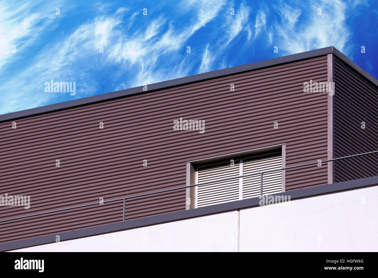 Abstract looking modern building detail against blue cloudy sky Stock Photo