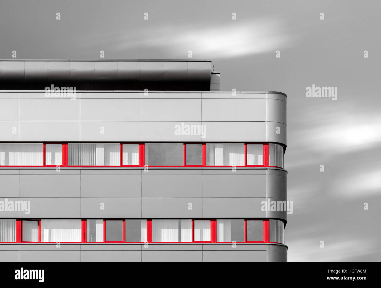 Abstract looking black and white modern building with red windows Stock Photo