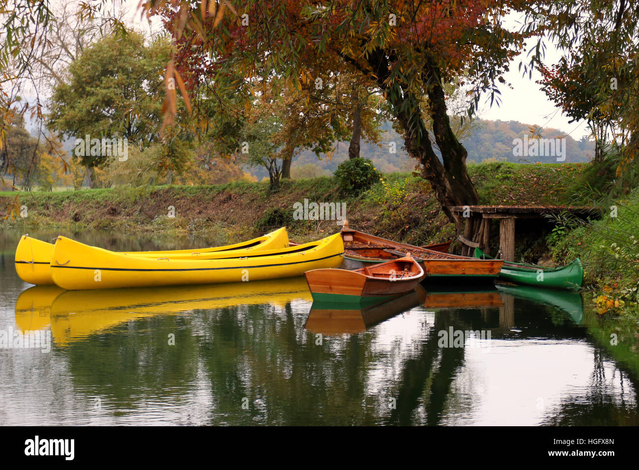 Row boats by the autumn river Krka, Slovenia. Stock Photo