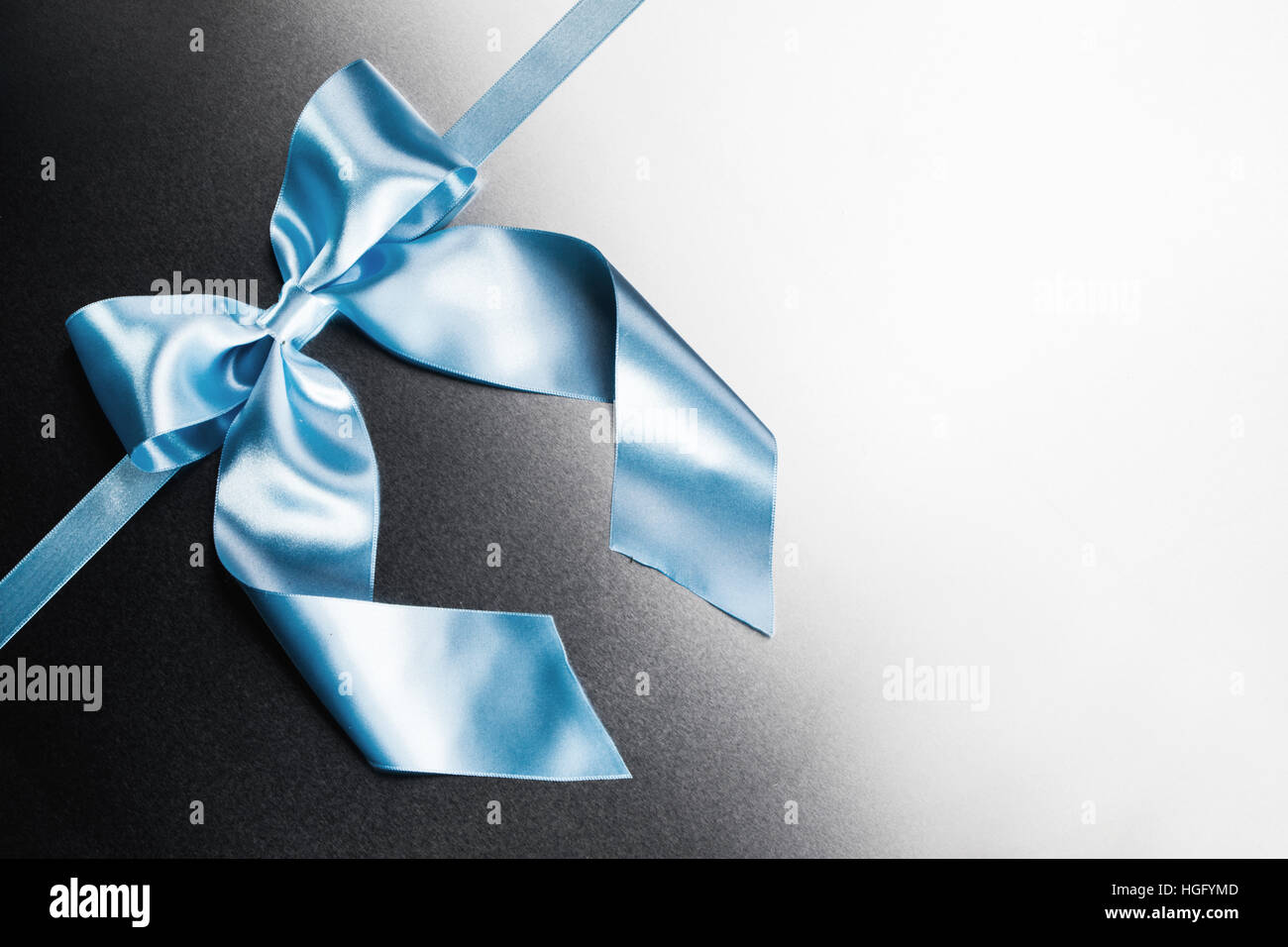Blue ribbon bow on metal background with white copy space Stock Photo