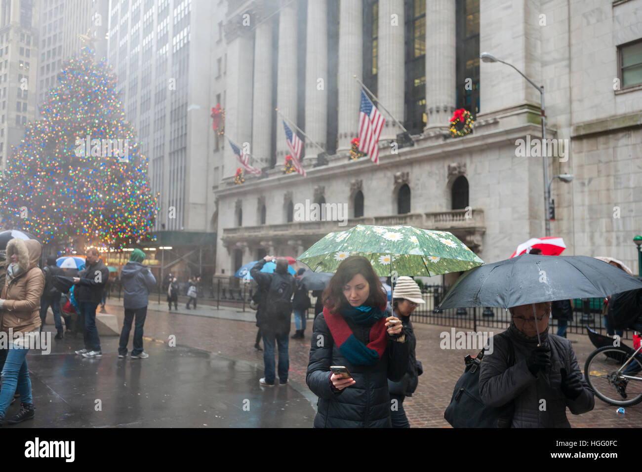 Tourists in front of the New York Stock Exchange on Thursday, December 29, 2016 with the facade decorated with wreaths. Many investors believe that the Dow Jones 20,000 figure will not be reached this year..  (© Richard B. Levine) Stock Photo