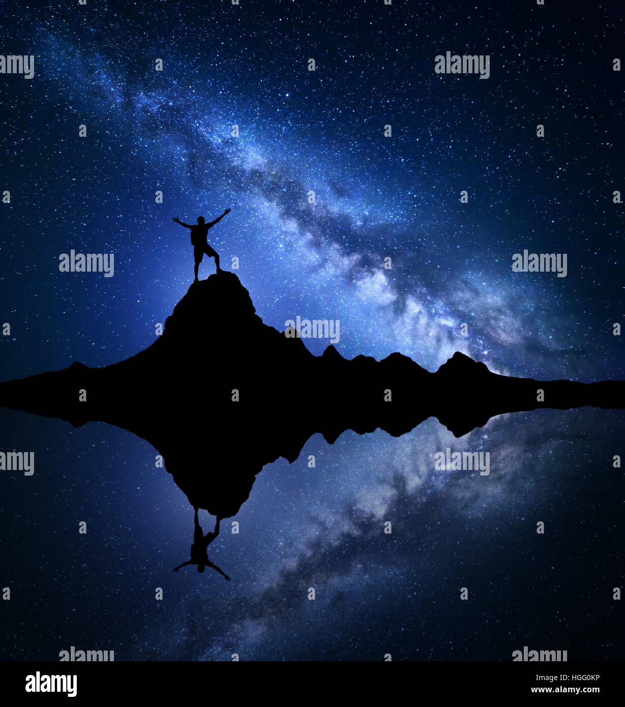 Milky Way. Night starry sky and silhouette of a standing happy man with ...