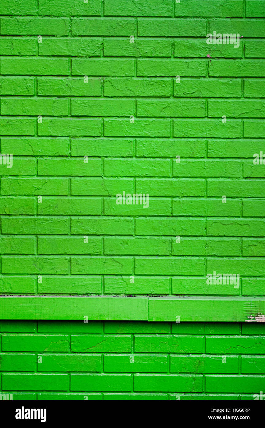 A bright green brick wall in New York city Stock Photo