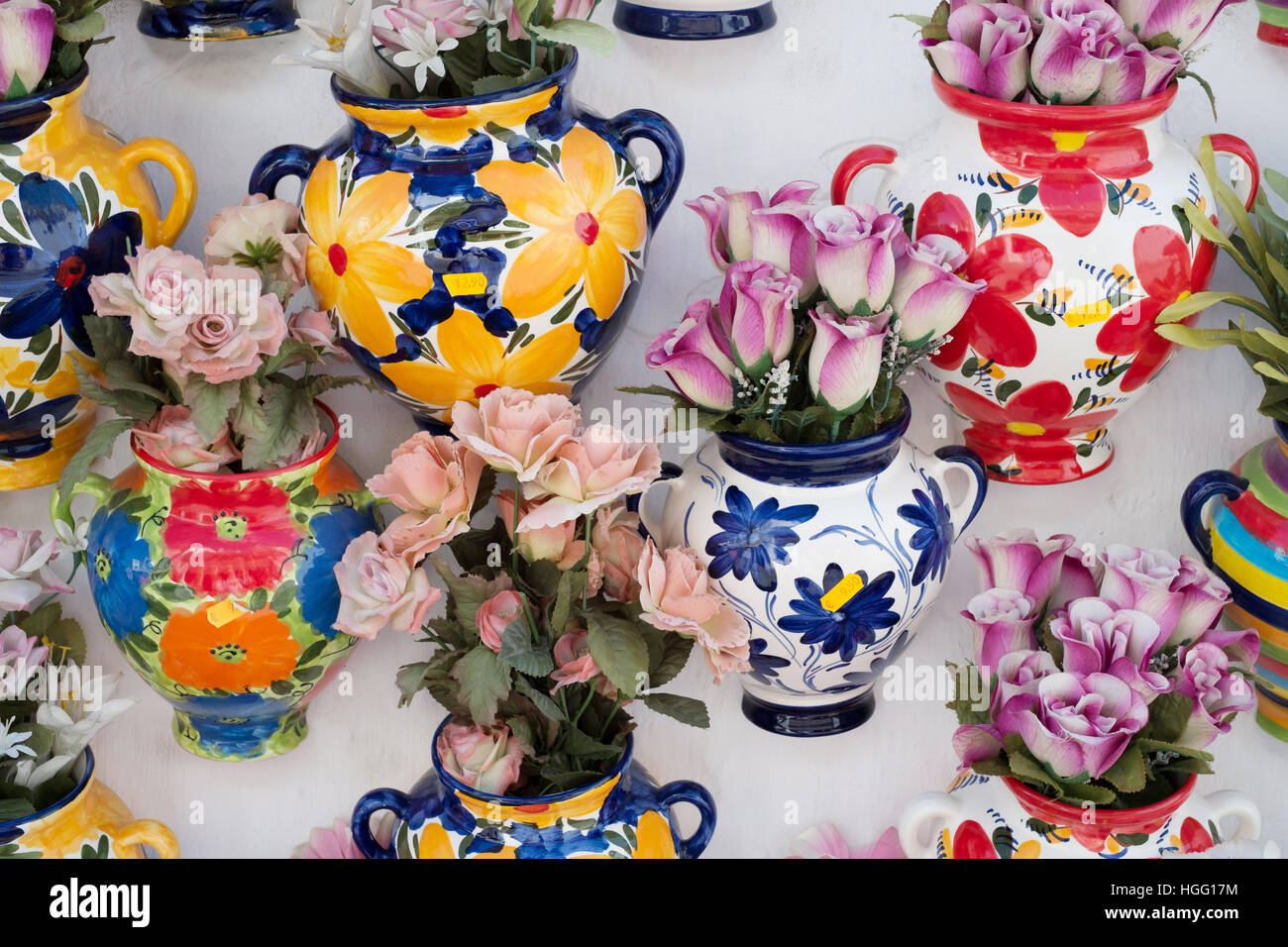 Colourful ceramic vases with flowers on a shop wall at Mijas, Costa del Sol, Andalusia
