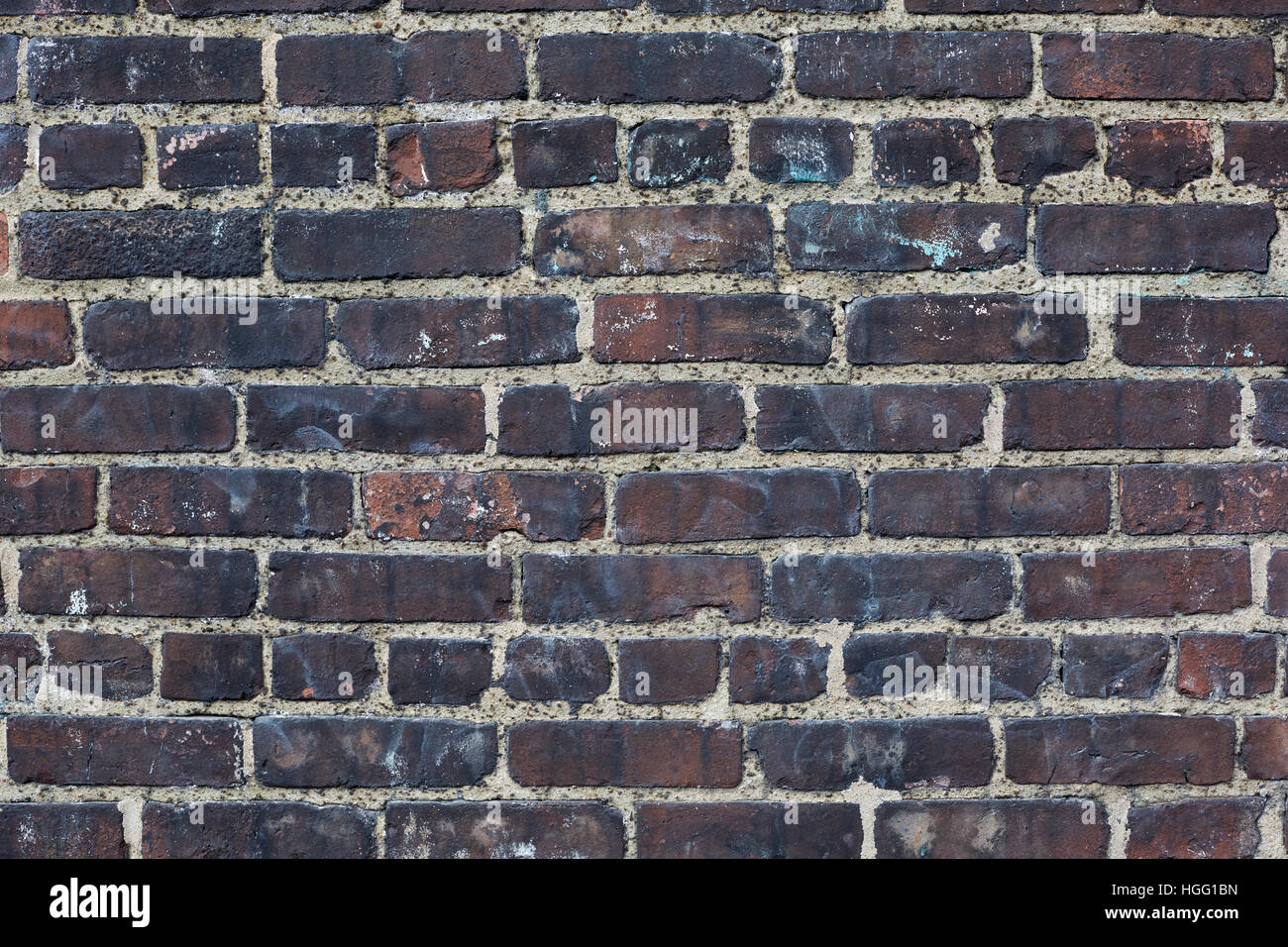 Dark bricks, blacken weathered wall texture background Stock Photo