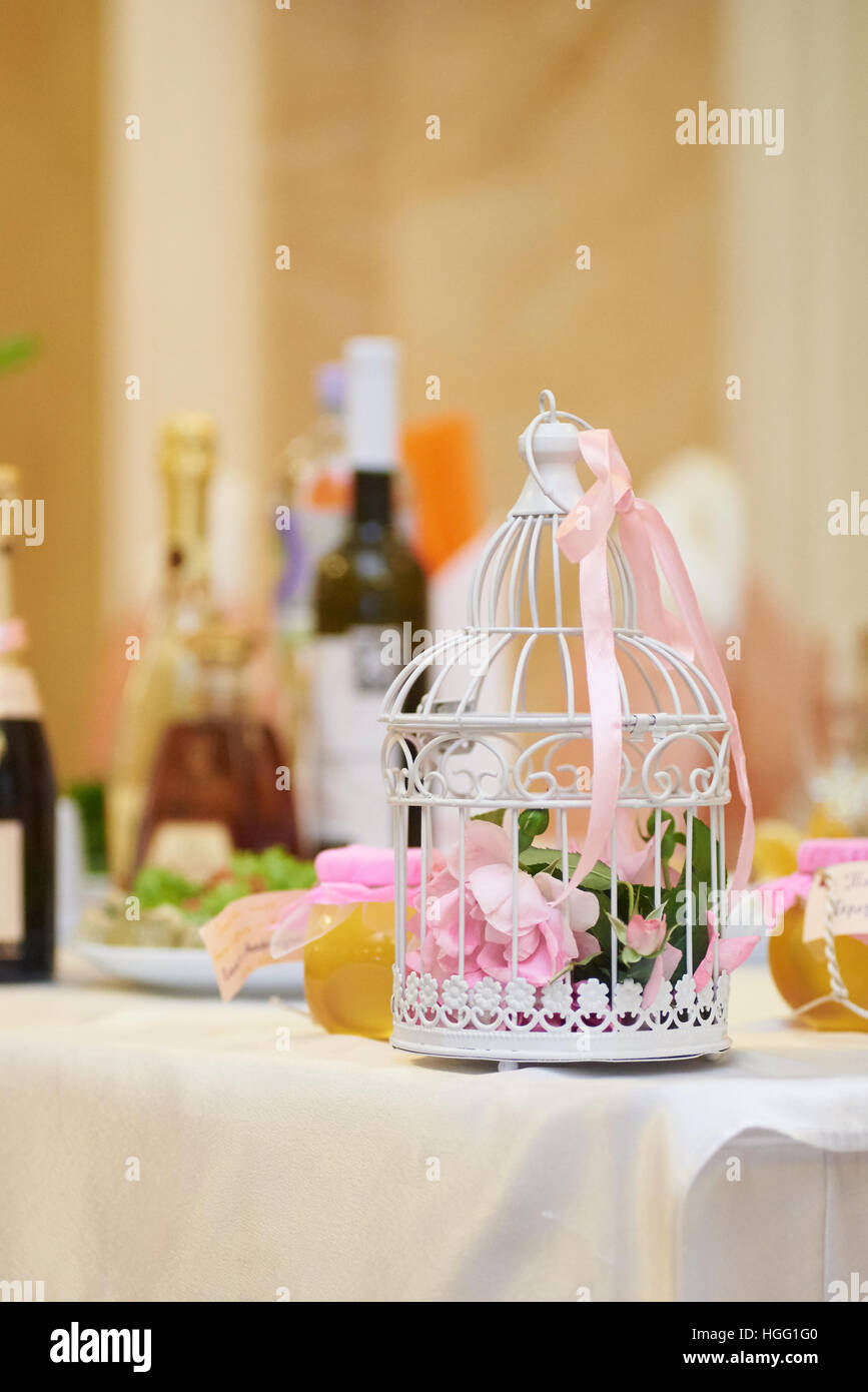 Wedding floral decoration in beautiful vintage birdcage. Wedding decor idea Stock Photo