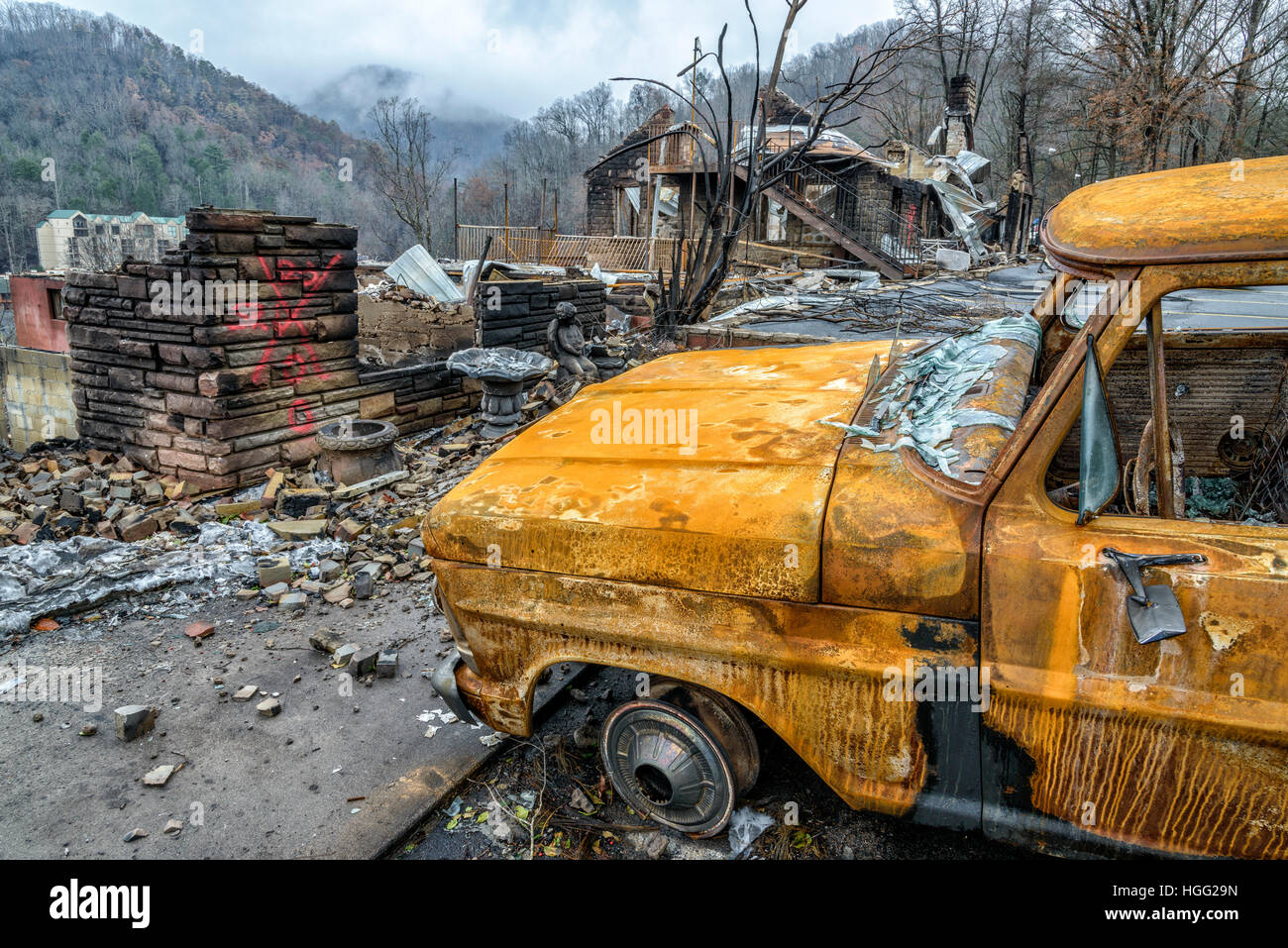 GATLINBURG, TENNESSEE/USA - DECEMBER 14, 2016: A cremated truck and a burned structure remain after a forest fire burned part of Gatlinburg in 2016. Stock Photo