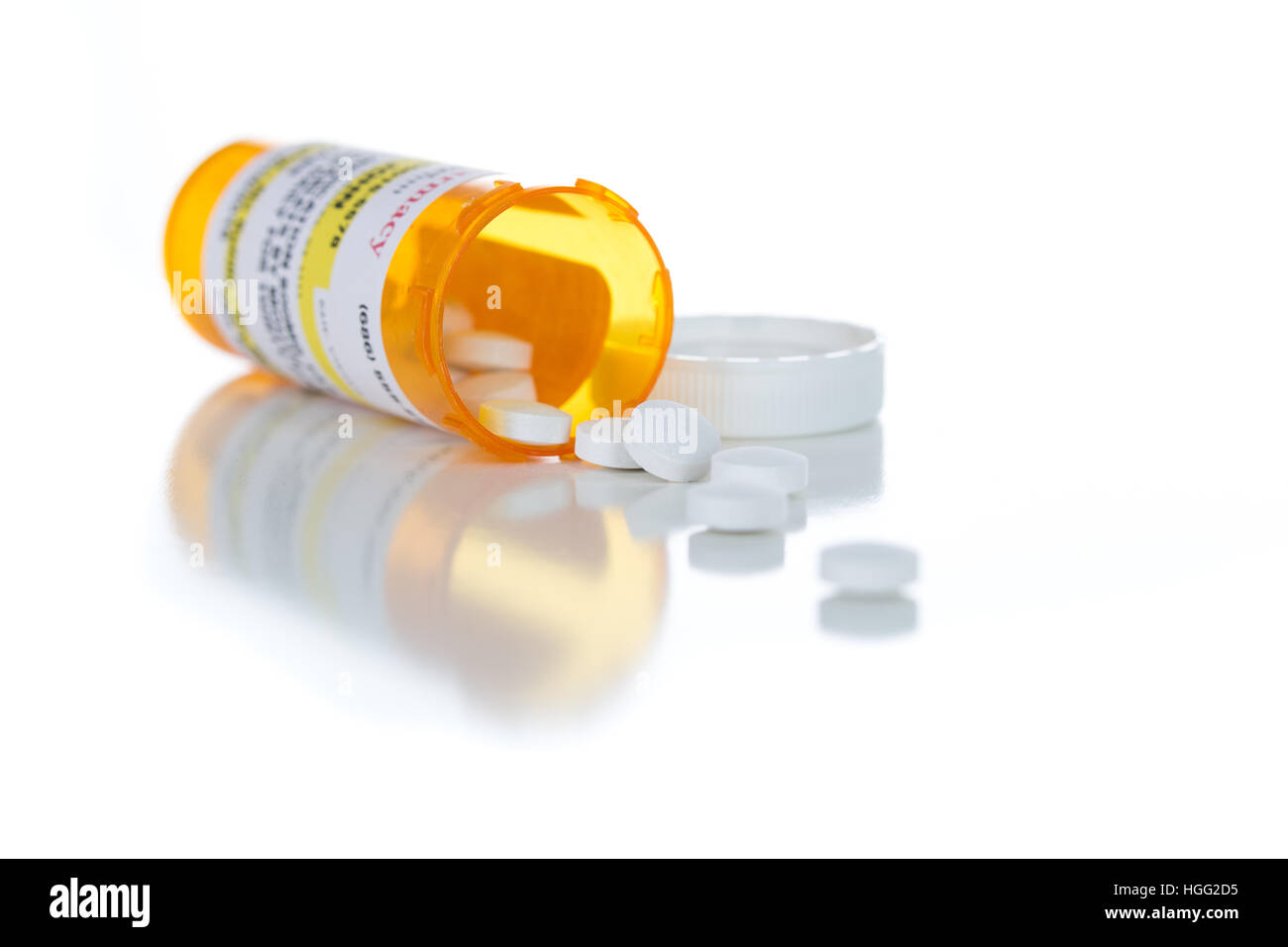 Non-Proprietary Medicine Prescription Bottle and Spilled Pills Isolated on a White Background. Stock Photo