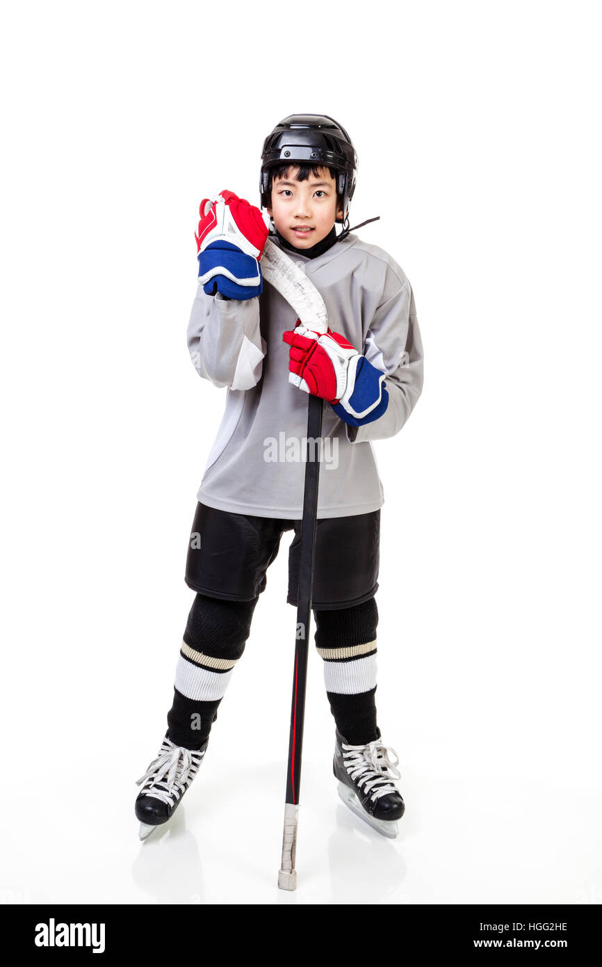 Junior ice hockey player with full equipment and uniform isolated on