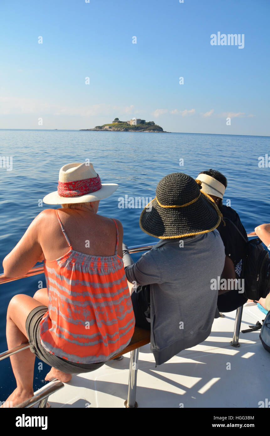 three woman of differing nationalities seated on a small boat touring islands on the adriactic sea near Herceg-Novi. Stock Photo