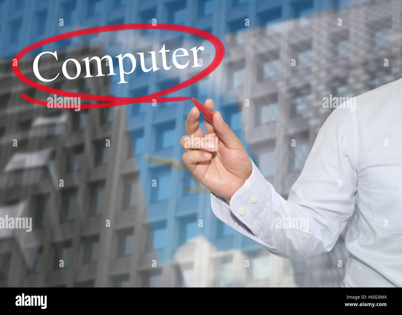 Hand of young businessman write the word Computer on skyscrapers background,concept of Apply to promote your business or work presentations. Stock Photo