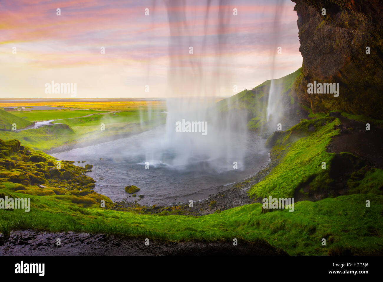 Colorful evening view from the middle of famous Seljalandfoss Waterfall. Braethtaken sunset in south Iceland, Europe. Stock Photo