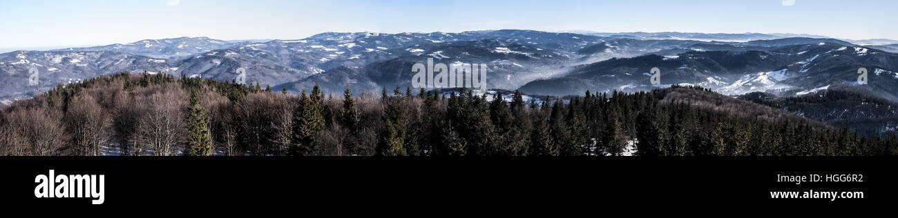 panorama of whole Tatras mountain range from Lysa hora hill in Moravskoslezske Beskydy mountains during winter day with clear sky and snow Stock Photo