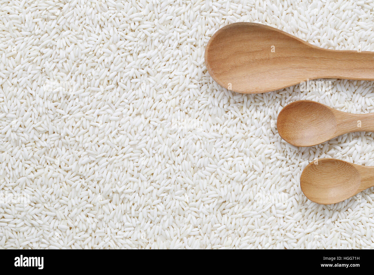 Wooden spoon of empty on organic white rice, glutinous rice or sticky rice for design nature foods concept. Stock Photo