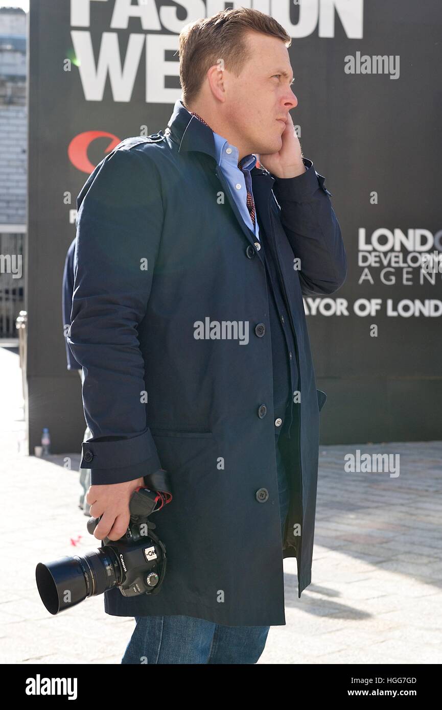 The American fashion photographer and blogger Scott Schuman, creator of The Sartorialist watches people at London Fashion Week. Stock Photo