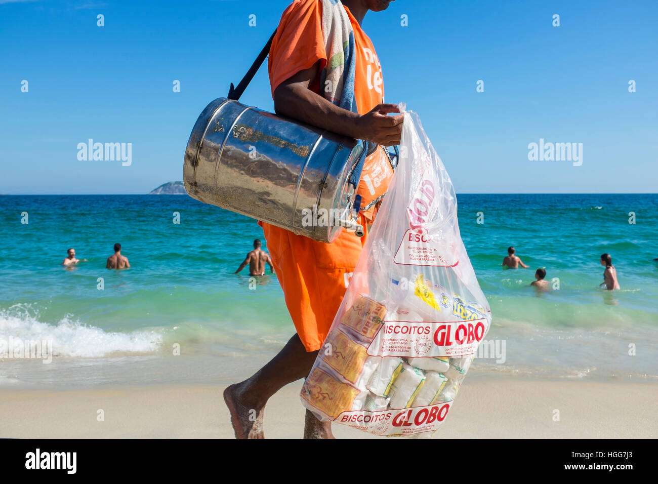 RIO DE JANEIRO - FEBRUARY 26, 2016: Beach vendor selling mate, the South American tea, and Globo brand biscuits, a local specialty, walks on Ipanema. Stock Photo