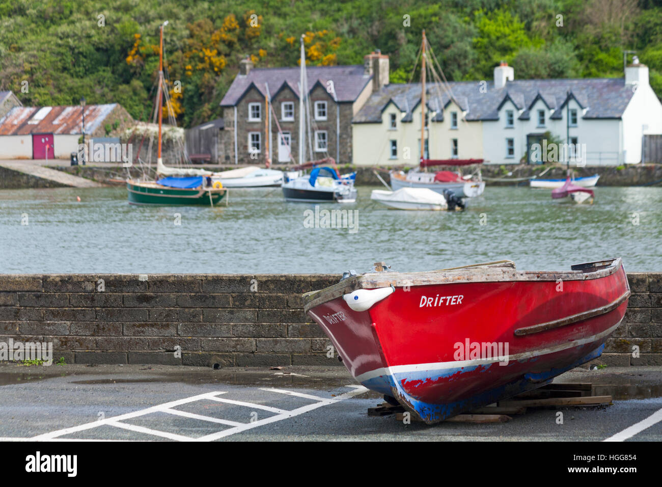 Drifter boat with cottages in the distance at Lower Fishguard or Abergwaun at Pembrokeshire Coast National Park, Wales UK in May Stock Photo