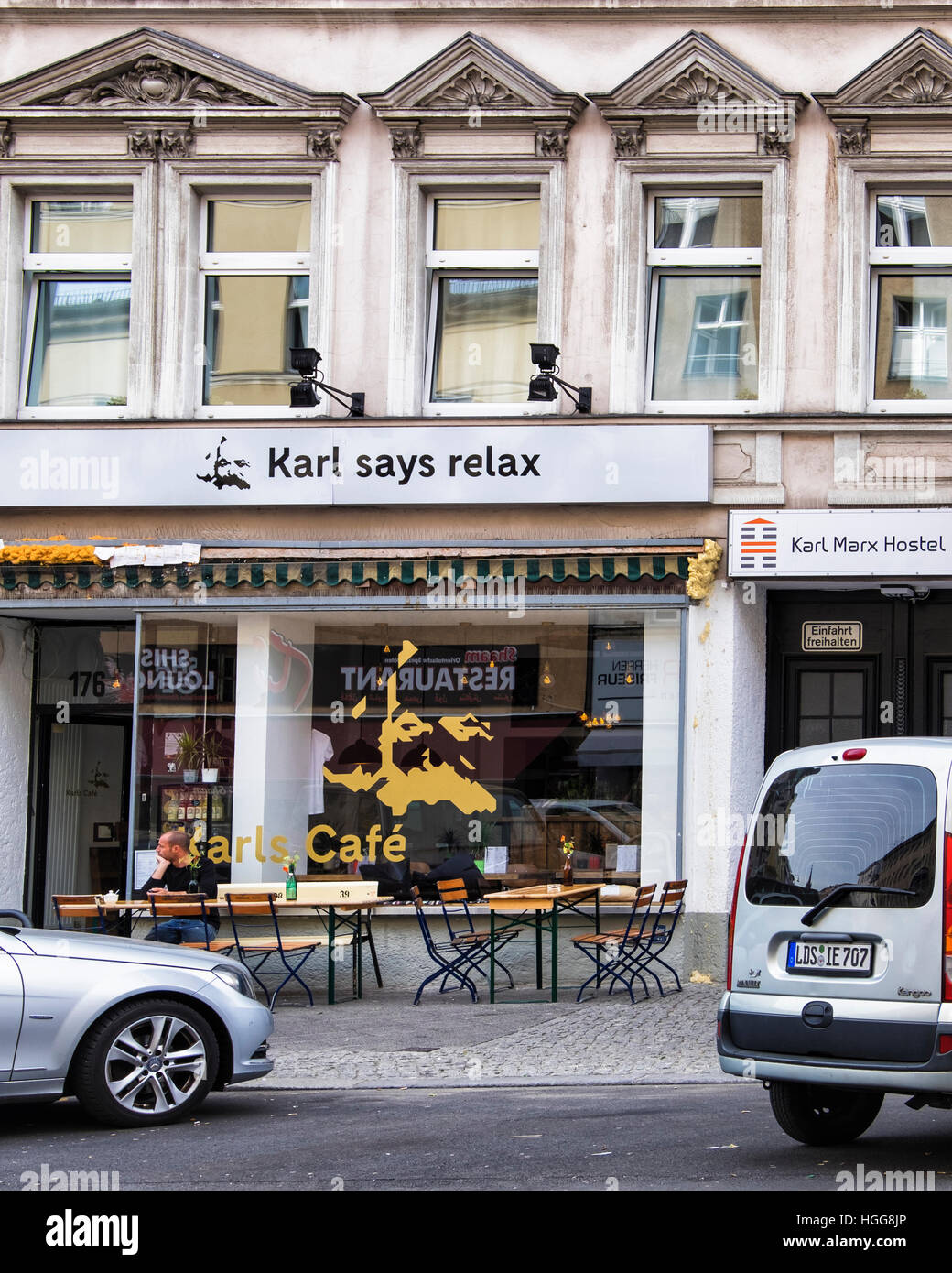 Berlin Neukölln, Karl Marx Strasse. Berlin urban street Karl Marx Hostel, Karl's Cafe and 'Karl says relax' slogan Stock Photo