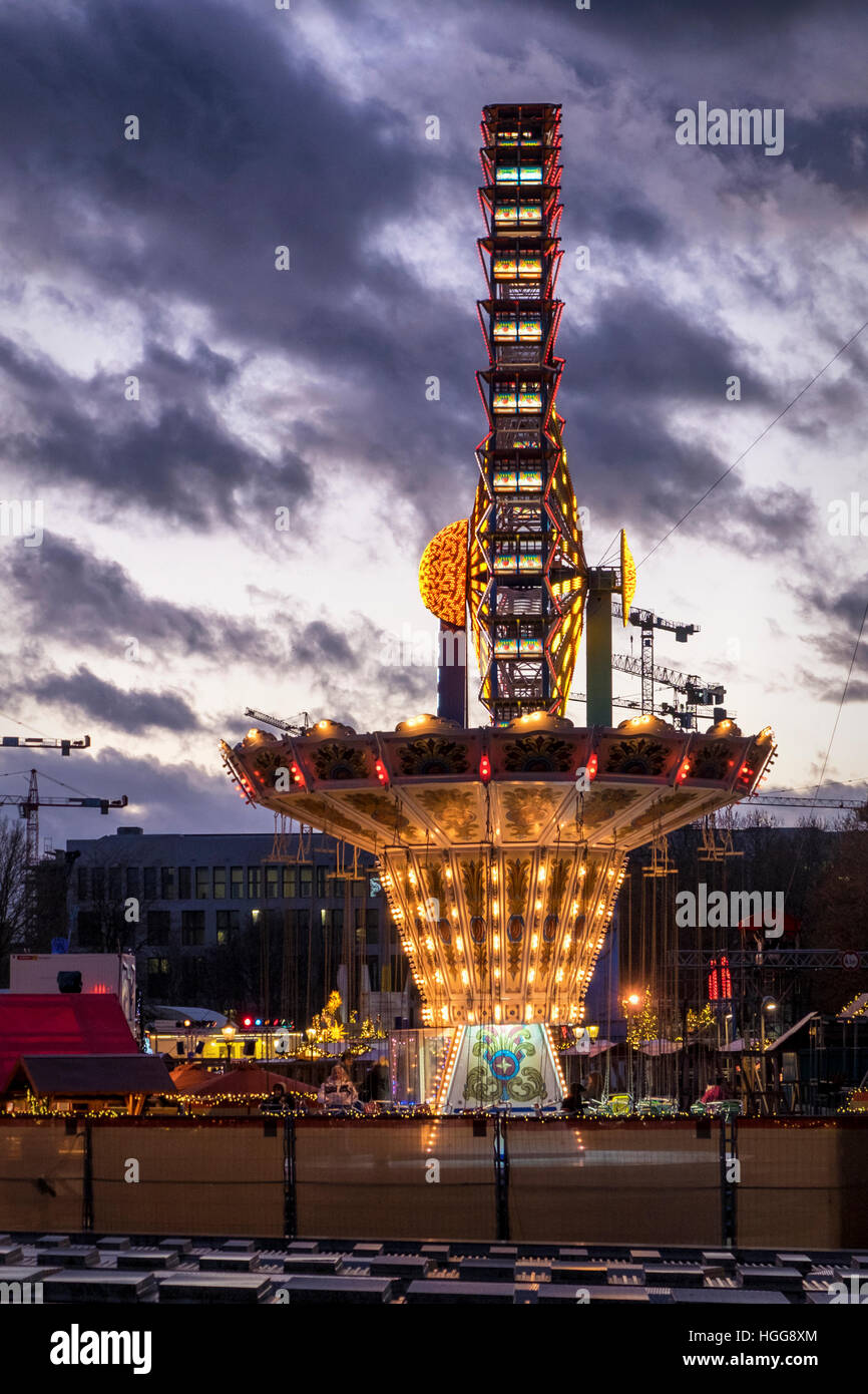 Berlin, Mitte. illuminated funfair rides, ferris wheel and carousel at ...
