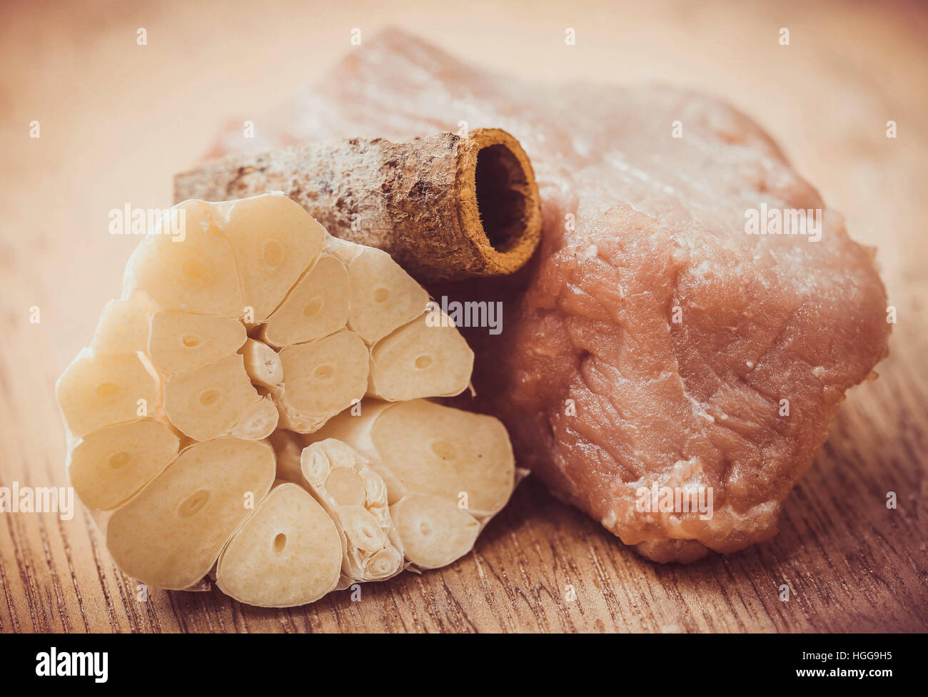 Raw beef with garlic and cinnamon on wooden surface Stock Photo