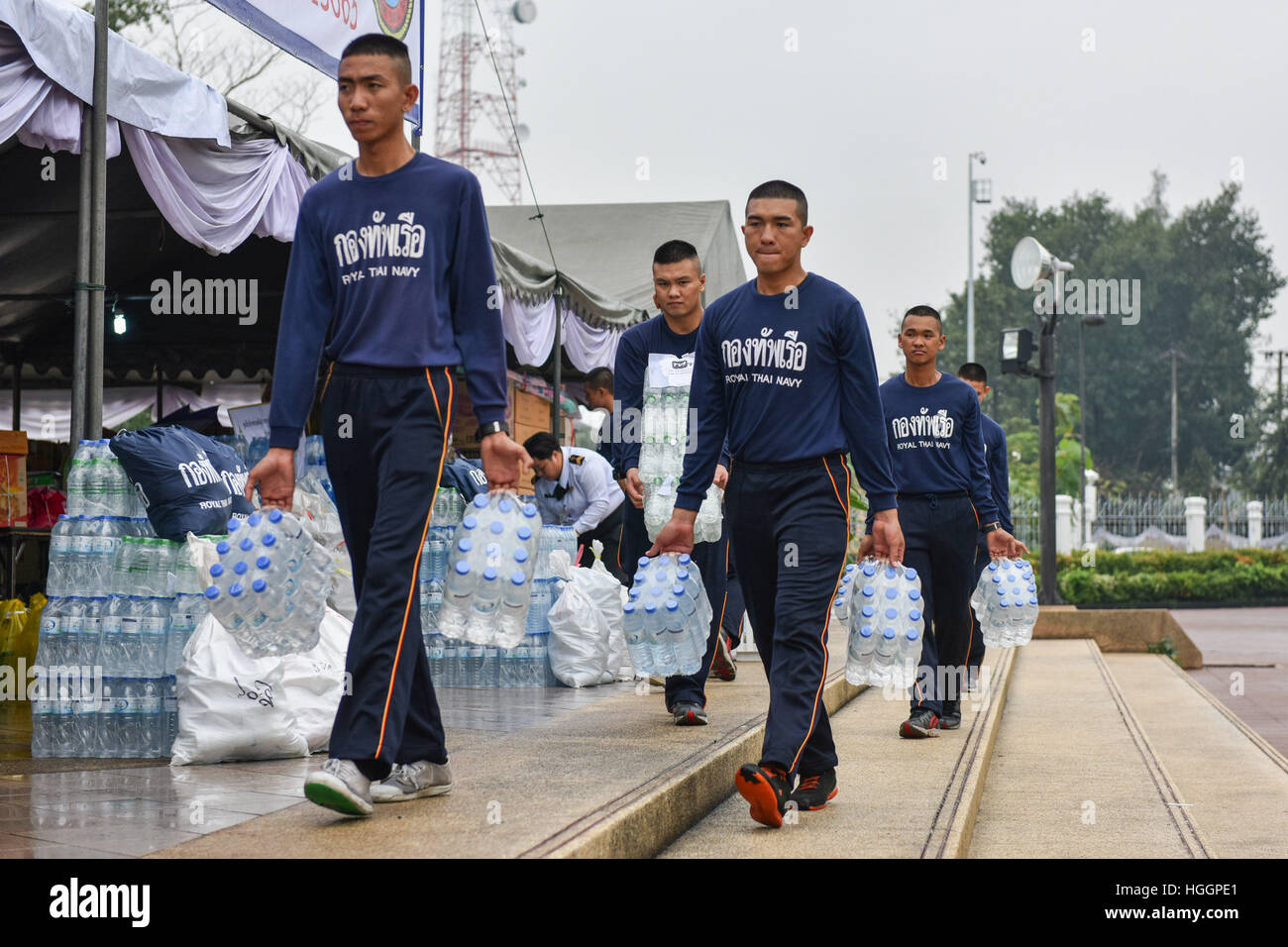 (170110) -- BANGKOK, Jan. 10, 2017 (Xinhua) -- Thai navy soldiers carry bottled drinking water donated by the public for the flooded southern provinces at a donation center set inside a naval base in Bangkok, Thailand, Jan. 10, 2017. The Thai government and military have set up donation centers which accept either cash or disaster relief materials from citizens in response to the severe flooding in the country's southern region. Persistent heavy rainfall has left Thailand's 12 southern provinces flooded, killing at least 21 people while affecting 330,000 households till Monday. (Xinhua/Li Mang Stock Photo