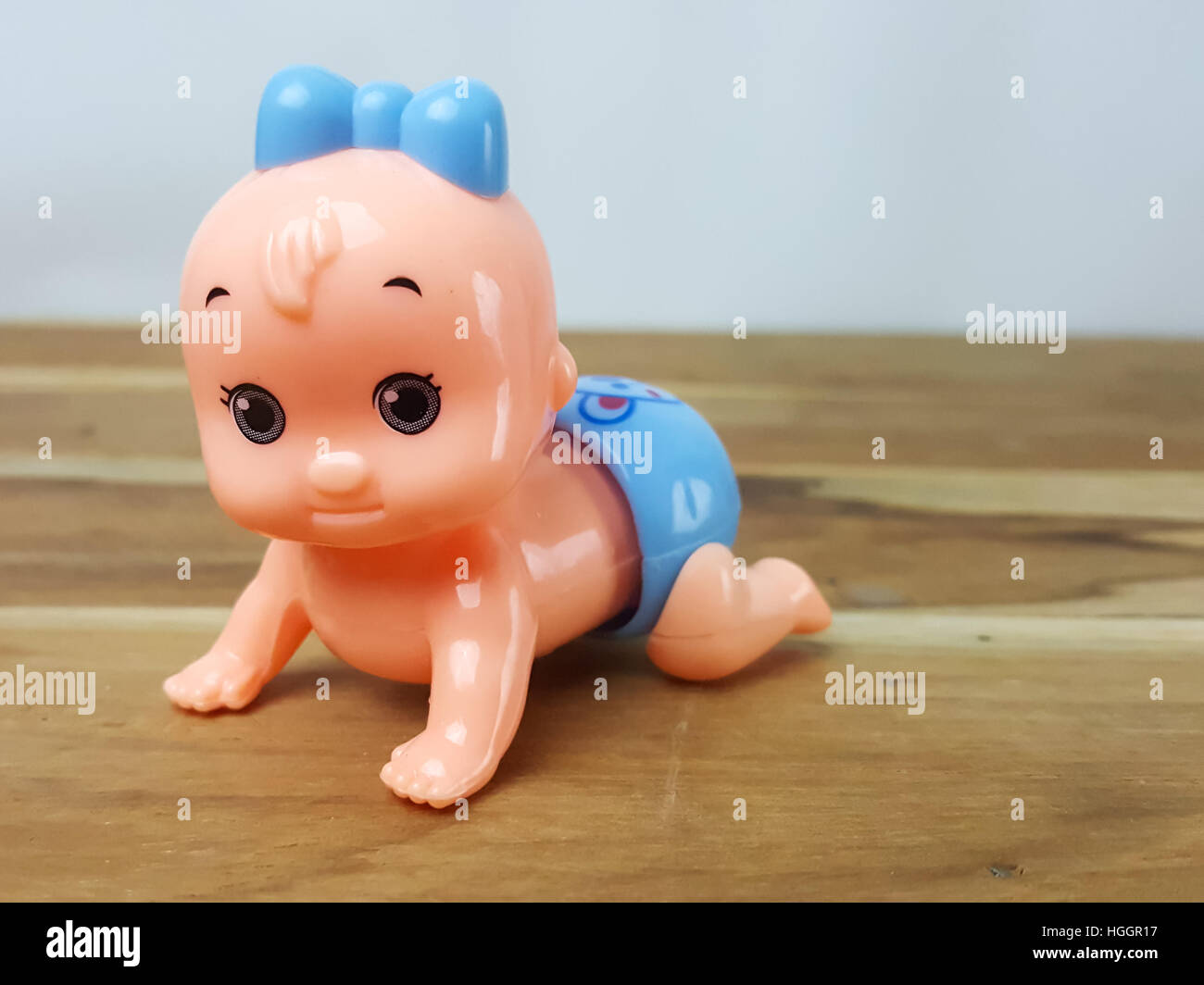 Mechanical wind up crawling baby toy on wood background Stock Photo Alamy