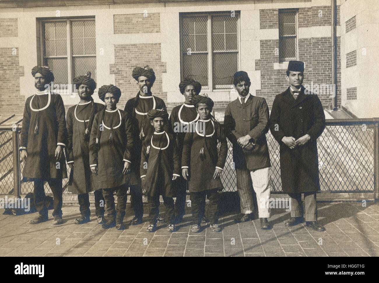 Group photograph of newly-arrived immigrants in native costumes, some with turbans, some with fezzes.  - Ellis Island Immigration Station 1902-1913 Stock Photo