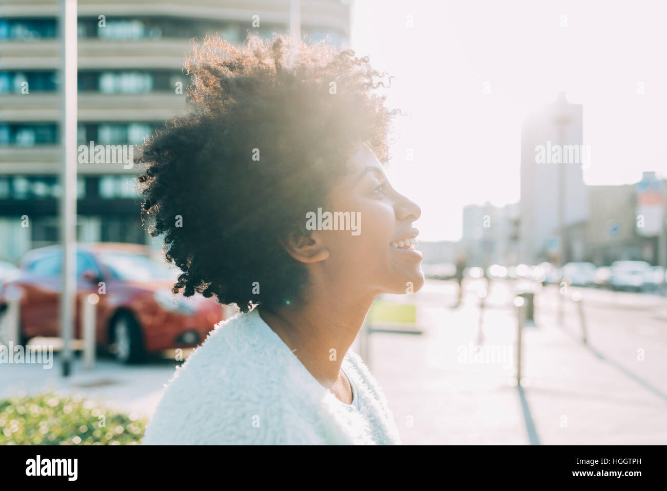 Portrait of young beautiful afro woman outdoor in the city back light ...
