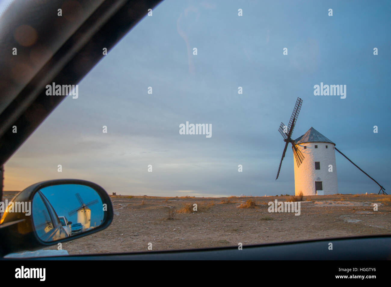 Windmill and reflection in the rear view mirror of a car. Campo de Criptana, Ciudad Real province, Castilla La Mancha, Spain. Stock Photo