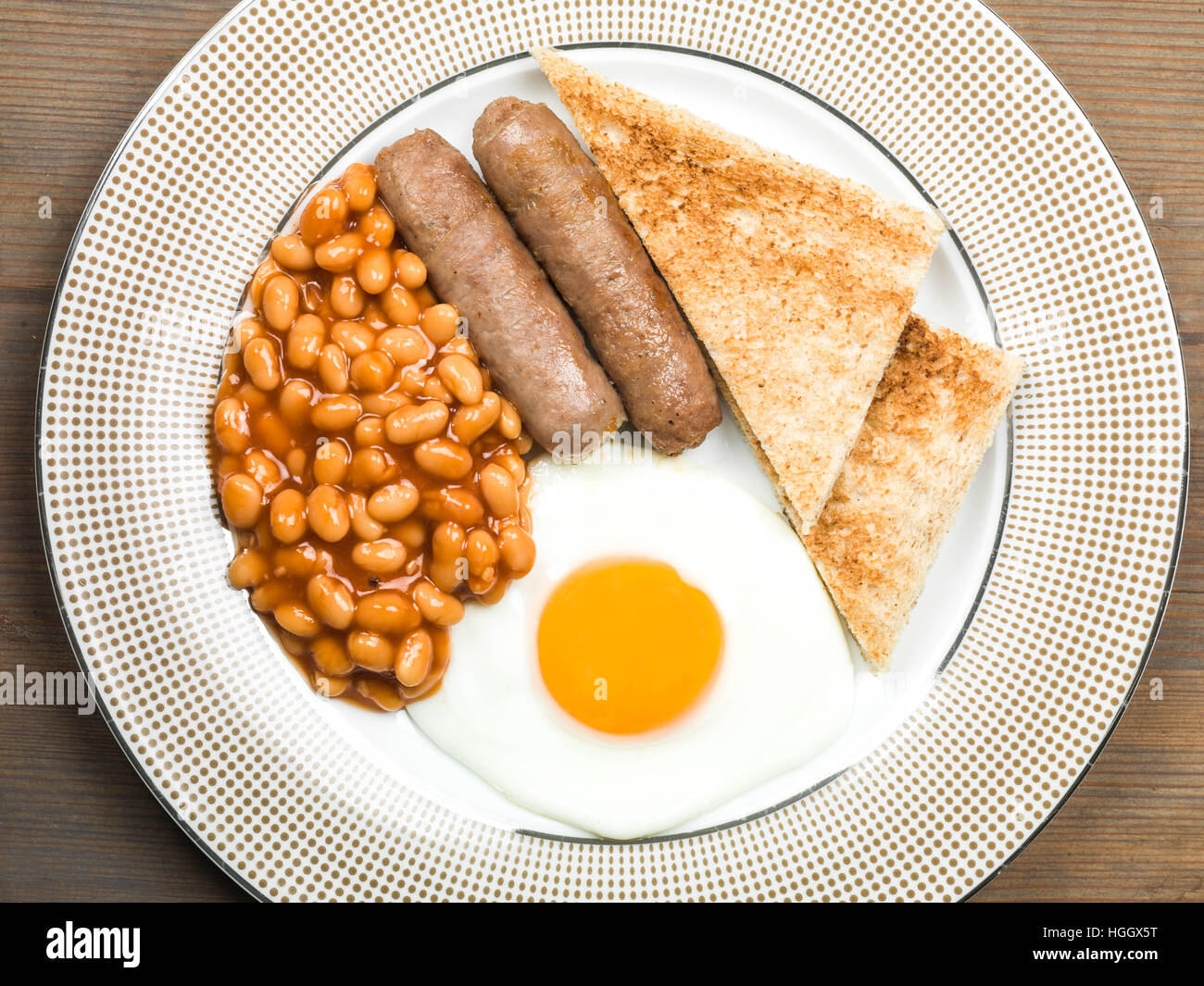 Cooked Fried English Breakfast of Pork Sausages Fried Egg and Baked