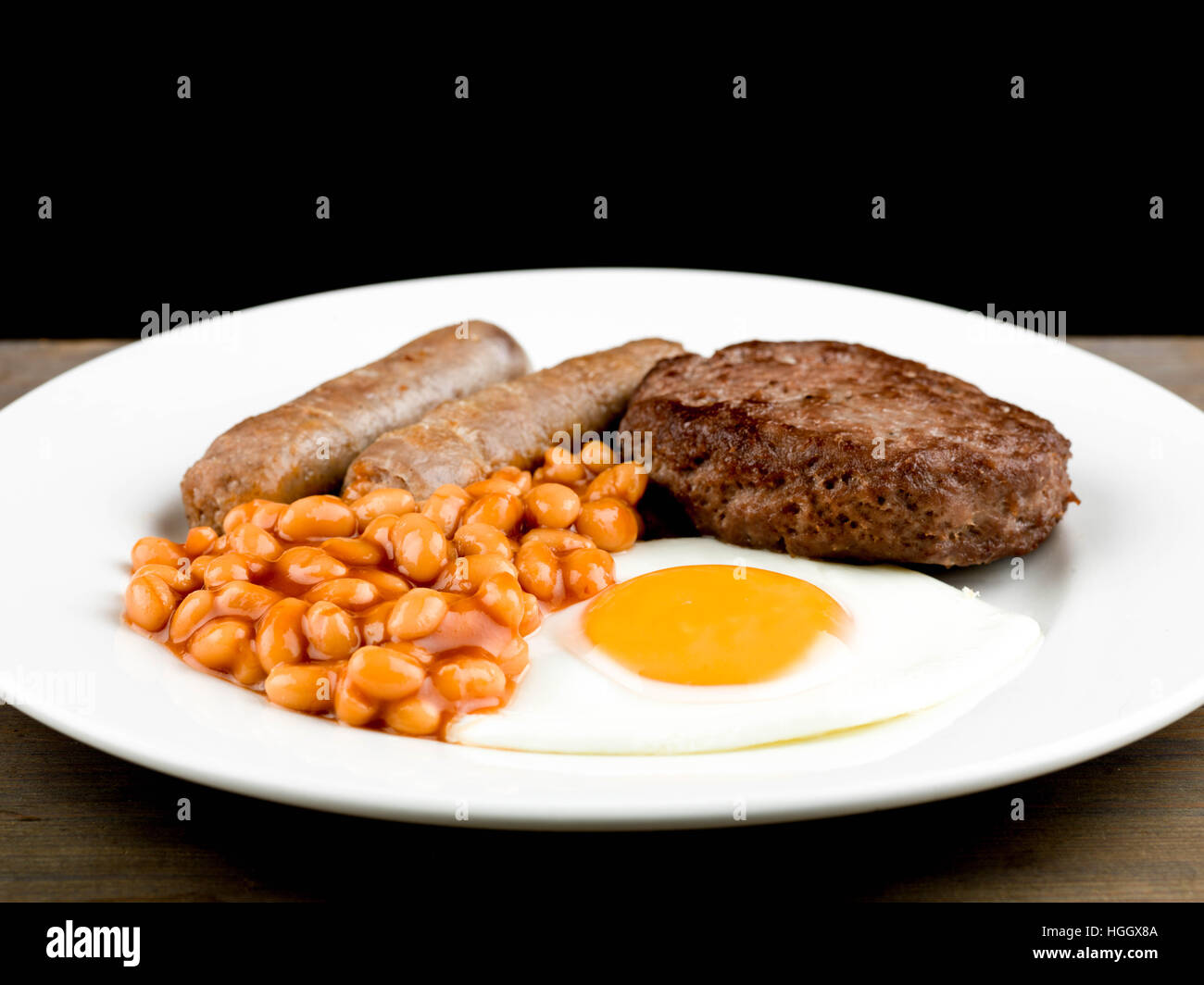 Fried Breakfast of Sausages Hamburger Baked Beans and a Fried Egg Stock