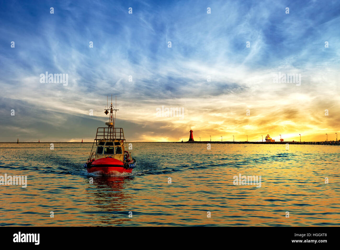 Pilot boat return to port at sunrise. Stock Photo