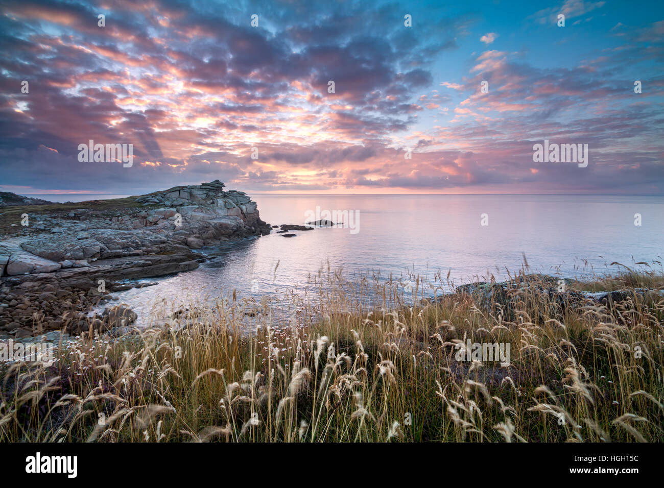 Giants Castle at sunrise with sunbeams breaking through the clouds, St Mary's, Isles of Scilly, July 2016 Stock Photo
