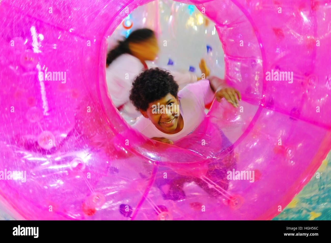 Two little boys have fun and laugh in a Water Ball colored Stock Photo