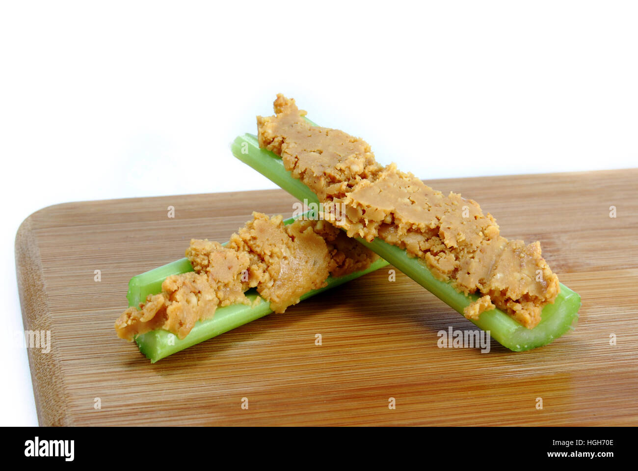 Preparing a Healthy Celery Stick Snack with Peanut Butter Stock Photo