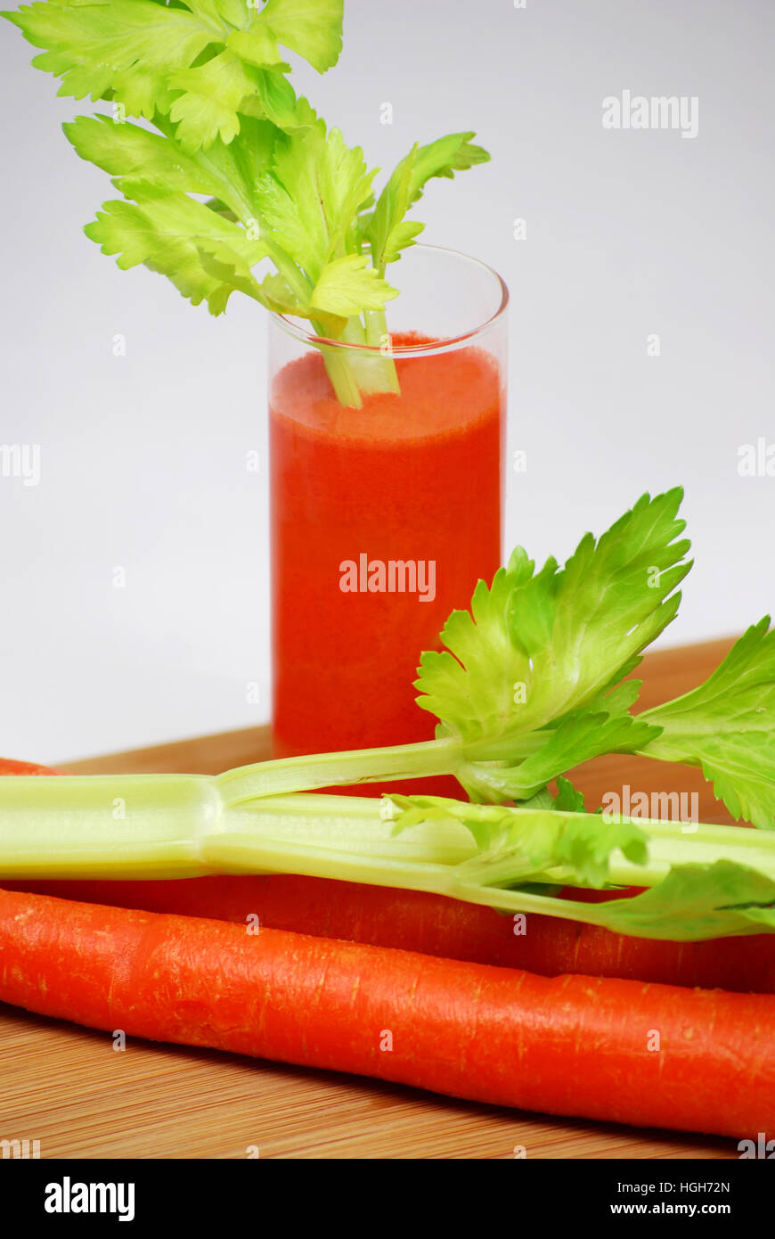 Fresh Raw Carrot Juice with Celery Stick. Health drink. Stock Photo