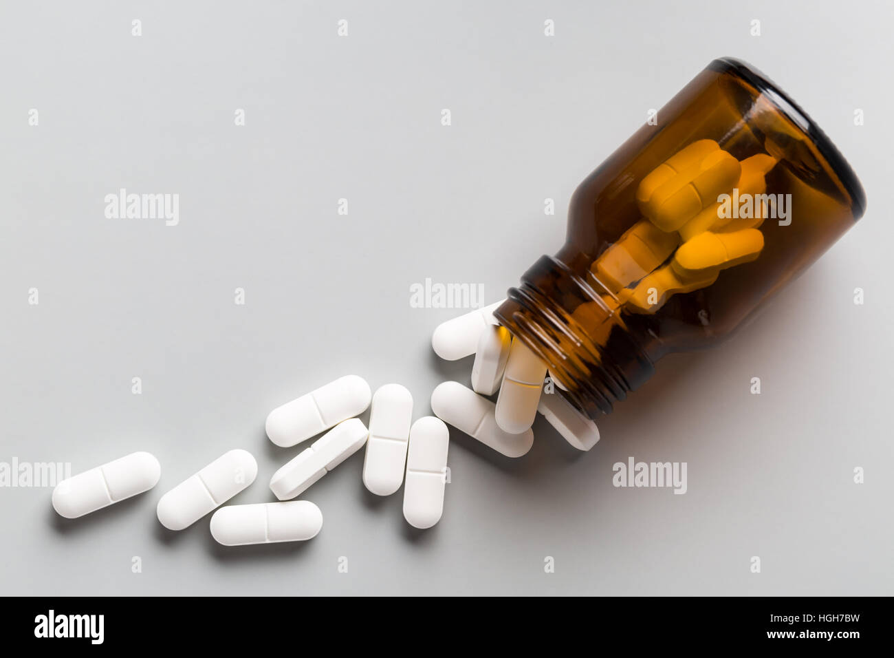 Glass bottle of white pills Stock Photo