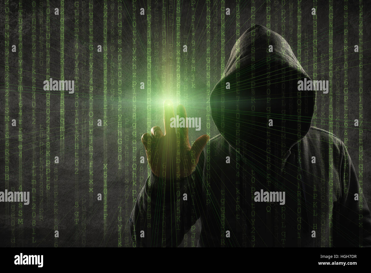 hacker over a screen with binary code Stock Photo