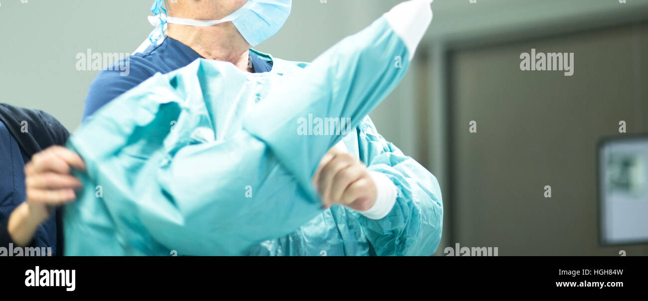 Surgeon in hospital surgery dressing in sterile uniform "scrubs" in