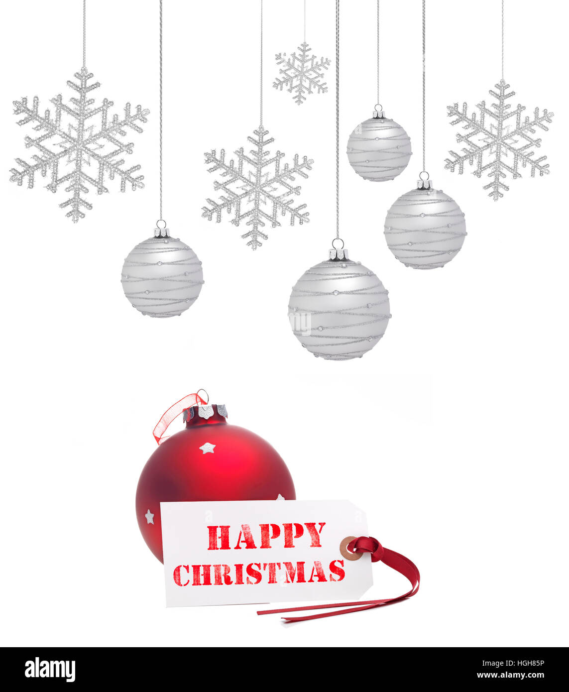 Red Christmas Bauble with space for copy and hanging snowflakes and Happy Christmas text Stock Photo