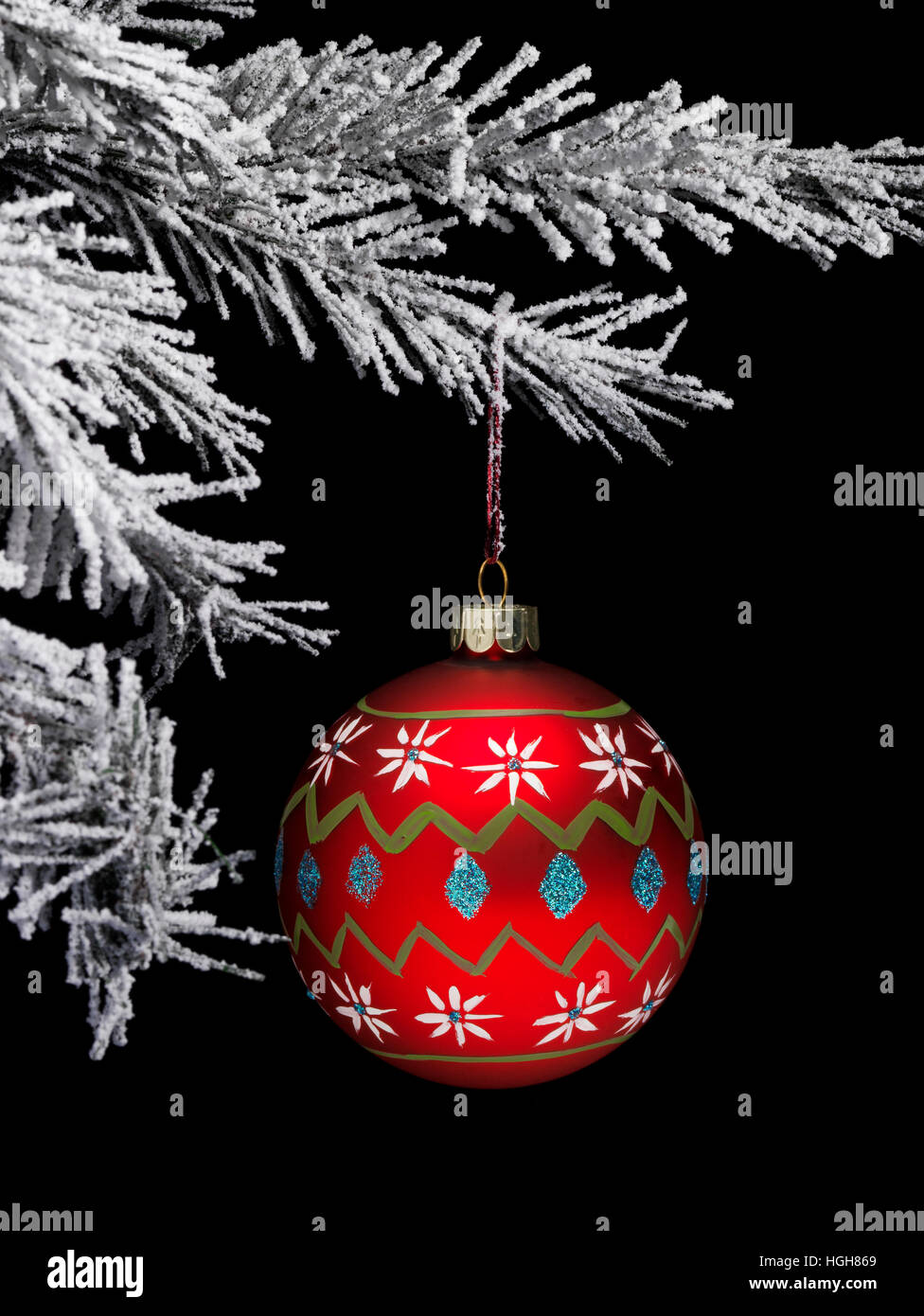 snow covered Christmas tree with a hand painted red Bauble Stock Photo ...