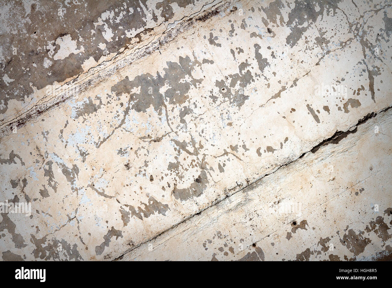 Concrete block wall background. Peeling white paint on concrete texture