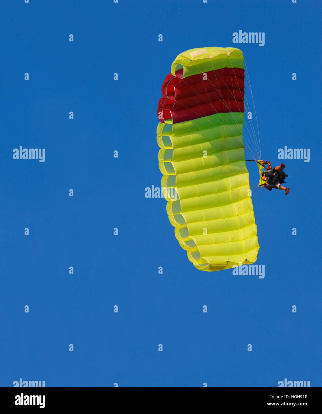 Yellow parachute on the blue sky Stock Photo