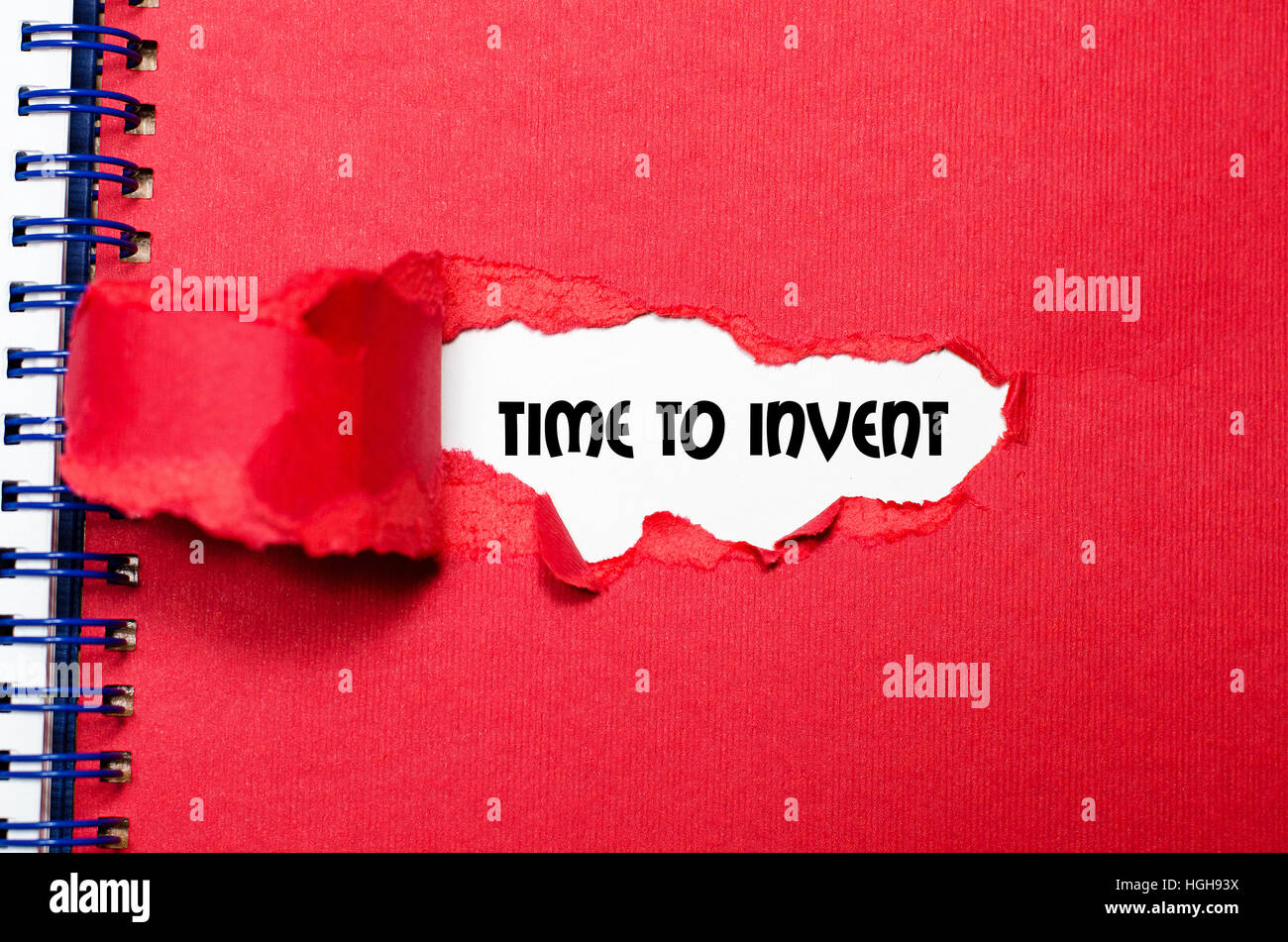 The word time to invent appearing behind torn paper Stock Photo Alamy