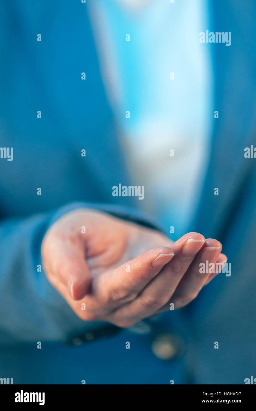 Businesswoman with open palm of her hand asking something Stock Photo
